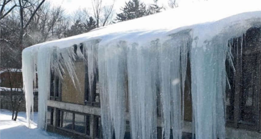 ice dam removal of large icicles on roof in grand rapids michigan